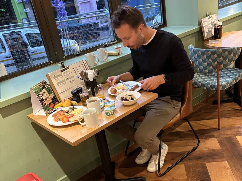 Martin u stolu se snídaní v hotelu Travelodge Edinburgh Central