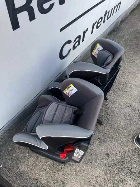 Child car seats beside the rental car return area